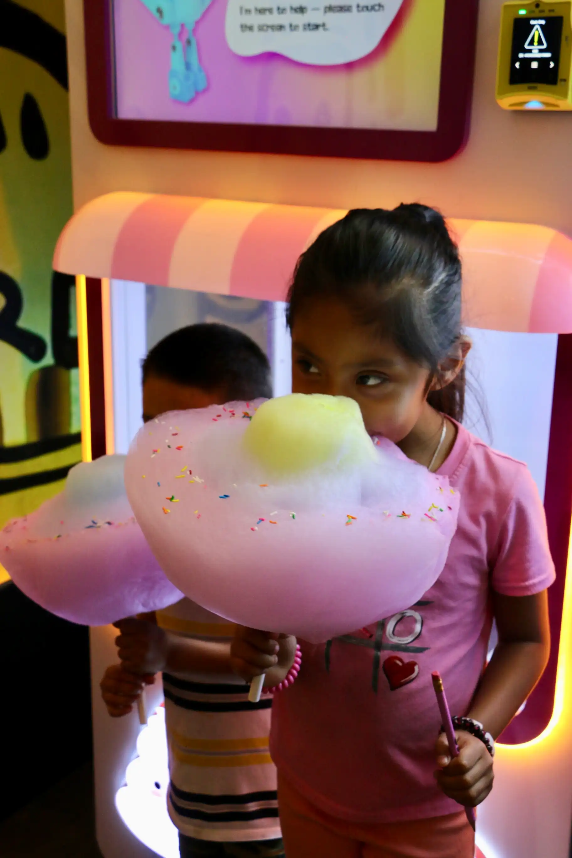 Girl holding a large flower-shaped cotton candy